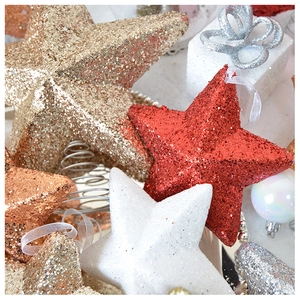 Close-up of glittery star Christmas ornaments with red, gold and copper sequins textures