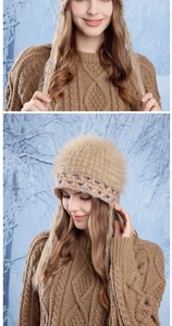 Detail of camel crochet hat with colorful accents and plush faux fur top in snow scene