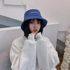 Blue corduroy bucket hat with coconut embroidery paired with a white oversized sweatshirt