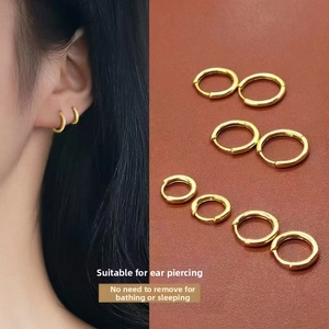Detailed comparison of various sizes of gold titanium steel hoop earrings on model and leather