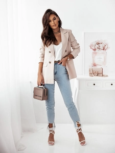 Fashion double-breasted blazer styled with lace camisole and distressed denim jeans