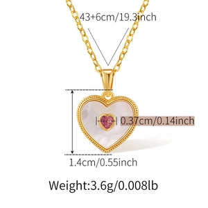 Macro detail of 18K gold plated heart necklace with pearl shell and pink gemstone
