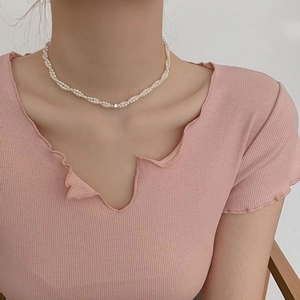 Elegant double-layer white rice pearl necklace with zircons shown on a model neck