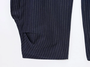 Detailed view of the fine striped linen blend fabric and stitching on the pocket of the pants
