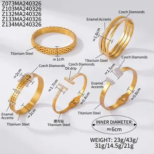 Detailed view of gold plated titanium steel bracelets with diamond inlay and enamel finish