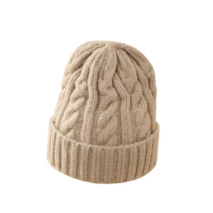 Thick cable knit beige beanie hat for winter featuring a classic cuffed design