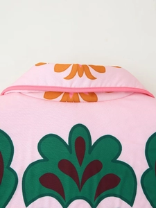 Detail of vibrant pink patterned cotton jacket showing neckline and texture