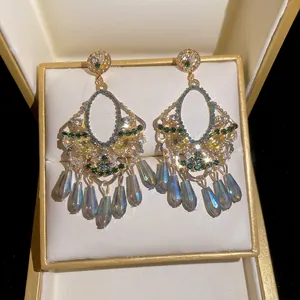 Vintage gold tassel earrings with green crystals and iridescent teardrop pendants