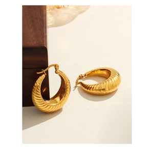 Macro di orecchini a U placcati in oro con design a spirale e trama stile croissant
