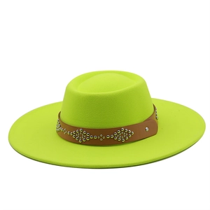 Detail of neon green wool fedora hat with brown leather band and silver metal rivets