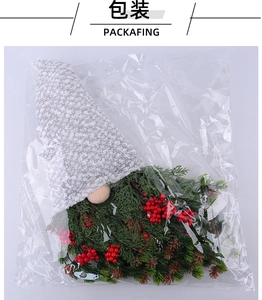 Detailed packaging view of a Christmas gnome wreath with red berries and pine cones