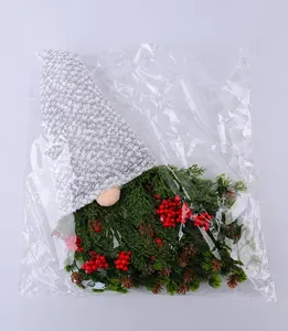 Detailed packaging view of a Christmas gnome wreath with red berries and pine cones