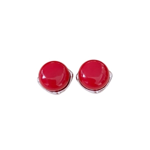 Chic red round stud earrings with silver pins and glossy finish on white background