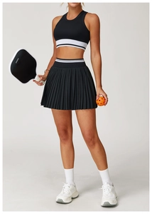 Detail of high-waist pleated tennis skirt with contrast white stripes and athletic texture