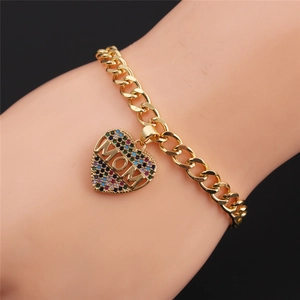 Detail of gold chain bracelet with heart MOM charm and multi-color rhinestones on wrist