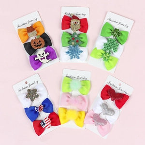 18-piece set of festive holiday hair bows with pumpkin, Santa, and clover patterns