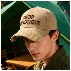 Close-up of khaki distressed baseball cap with 3D embroidery and vintage ripped brim details