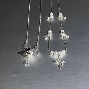 Elegant two-piece silver star and pearl necklace set with shimmering crystal pendants