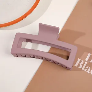 Macro detail of a large matte mauve square hair claw clip for elegant updos