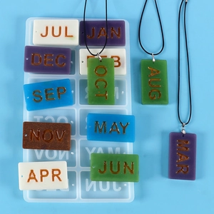 Macro detail of DIY monthly tag resin silicone mold with colorful calendar pendants