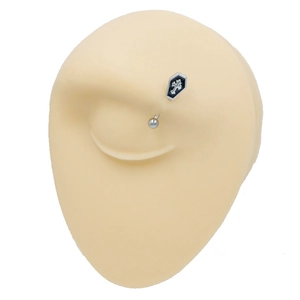 Minimalist curved eyebrow ring with black coffin and cross detail on silicone model
