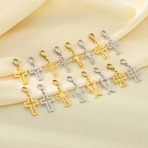 Assorted gold and silver hollow cross pendants displayed on elegant silk fabric