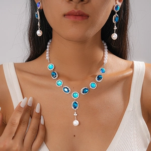 Vintage necklace and earring set with blue crystals and pearls on model