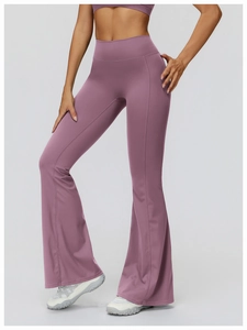 Detail of high-waisted flared yoga pants in dusty rose featuring tummy control and slim fit