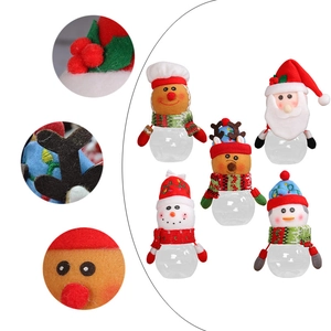 Christmas candy jars with Santa, Snowman, and Reindeer plush toppers on clear plastic bases