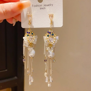Detail of vintage silver fringe earrings with water-drop stones and elegant pearls