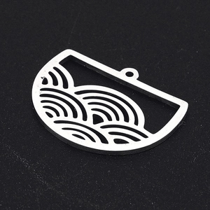 Macro view of silver stainless steel crescent charms with intricate wave pattern detailing