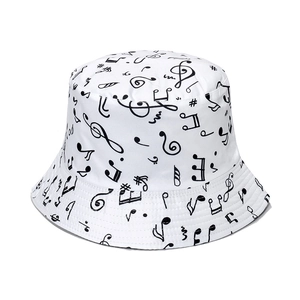 White cotton bucket hat featuring all-over black music note prints and artistic patterns