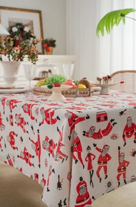 Detail of Santa Claus print on beige cotton linen Christmas tablecloth for dining