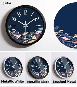 Close-up of decorative aluminum wall clock dial with feather art and metal frame options