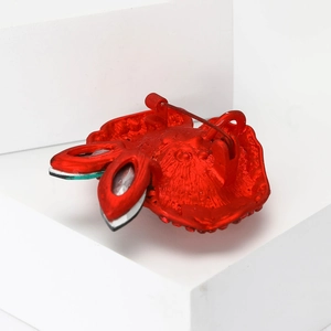 Detail view of the red enamel rose brooch back with a secure metal pin clasp fastener
