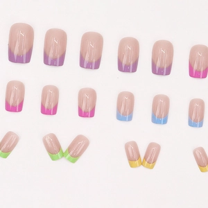 Rainbow French tip press-on nails with multi-color candy edges on nude pink base
