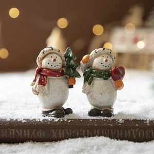 Charming resin snowman figurines with scarves on snowy book base for Christmas decor
