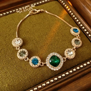 Macro detail of multicolored gemstone bracelet with sparkling crystal borders on velvet