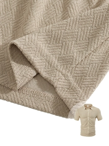 Macro detail of the beige waffle knit fabric texture and premium stitching on the men's shirt