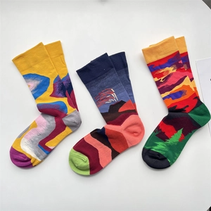 Detailed macro view of three artistic jacquard knitted cotton socks with colorful patterns