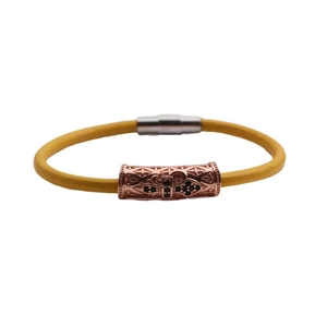 Detail of yellow beaded bracelet with rose gold hollow metal charms and magnetic clasp