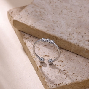 Detail of adjustable silver fidget ring featuring three movable beads for stress relief
