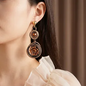 Vintage bohemian woven round earrings with gold wire and dark brown crystal beads for women
