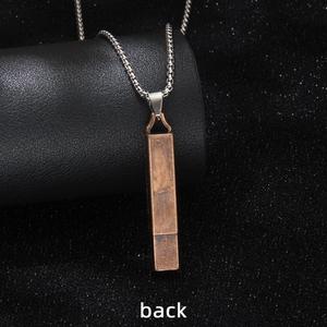 Vintage bronze square whistle pendant necklace with silver chain shown from the back view