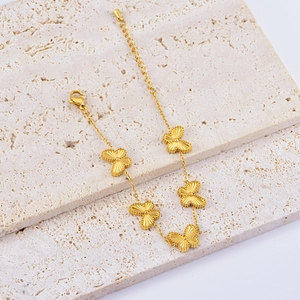 Macro view of golden butterfly necklace with adjustable extension chain on stone