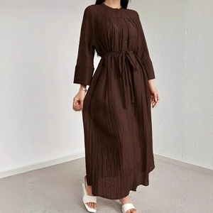 Detail of dark brown long-sleeve dress with pleated texture, buttons, and matching belt