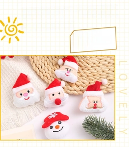 Detail of plush Santa Claus and snowman patches with embroidery and red hats for DIY craft