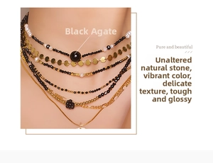 Detail of layered black spinel and gold beaded necklace set with a floral pendant