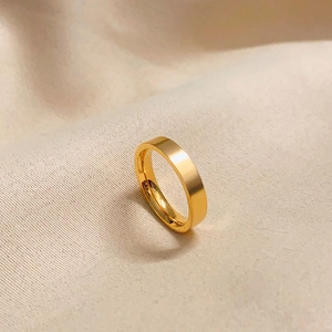 Detail of classic gold plated matte ring on soft fabric highlighting premium texture