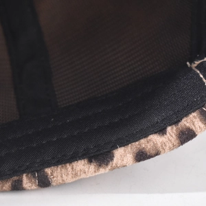 Close-up of leopard print baseball cap showing fabric texture and mesh stitching details